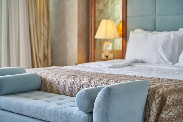 Serene hotel room with a comfortable bed adorned with white linens and pillows.